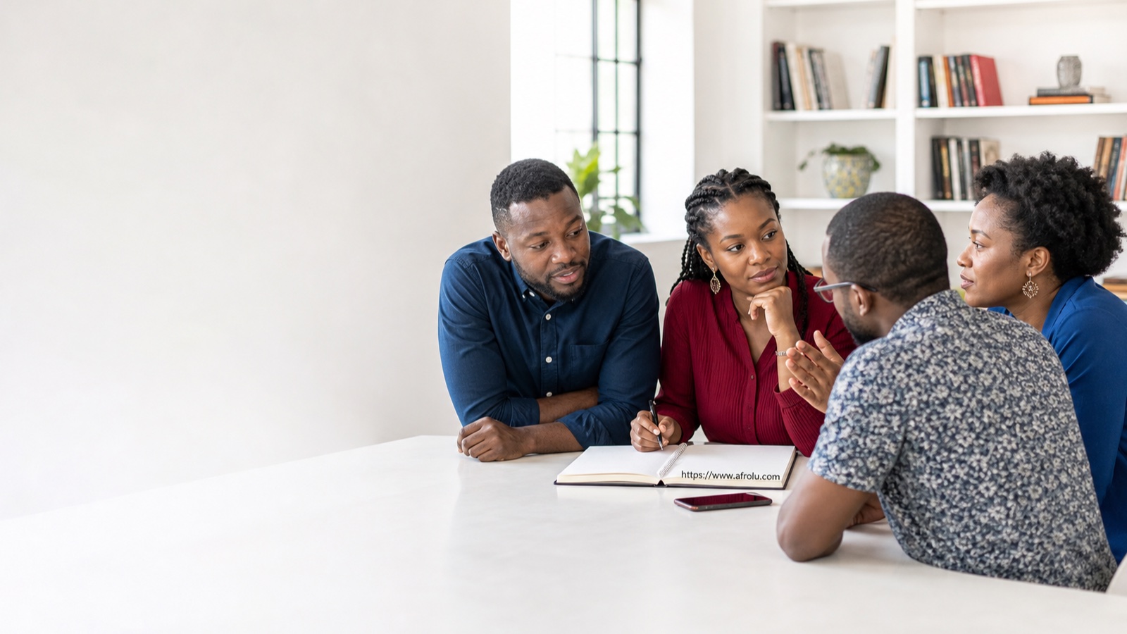 Four African adults discussing relationship guidance at a bright editorial table.