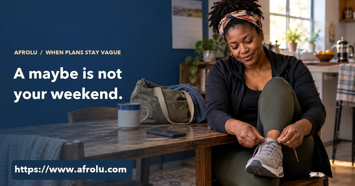 A parent at home ties walking shoes while a phone rests face down beside a weekend bag.