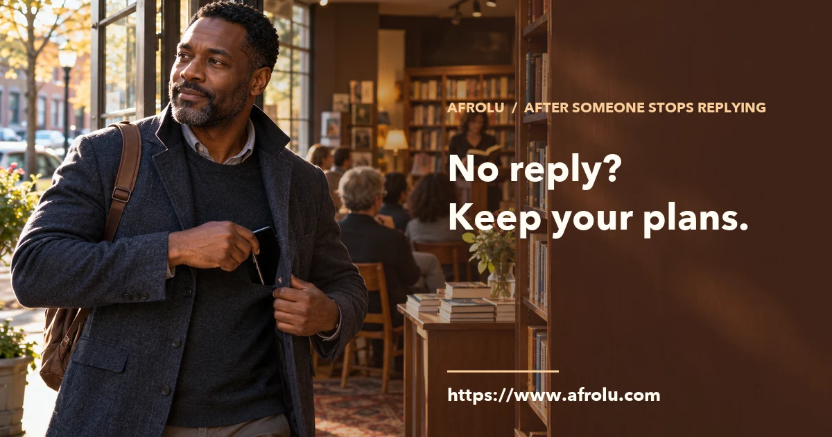 A middle-aged adult puts away his phone as he arrives at a public bookshop event.