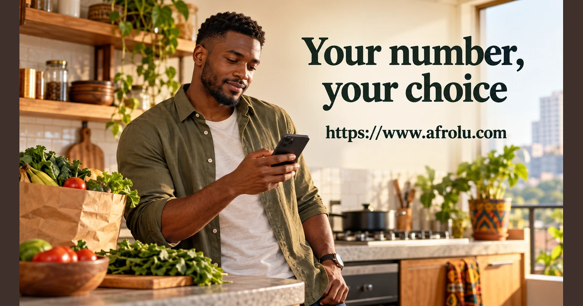 A man holds a phone in a kitchen.