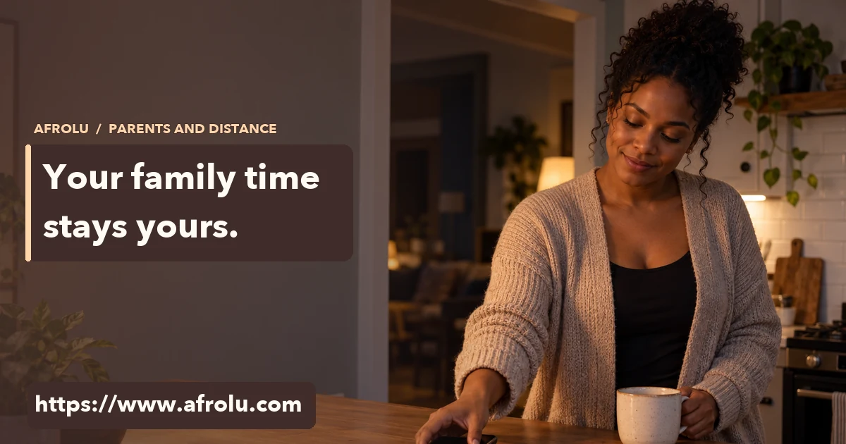 Adult Black mother in a warm kitchen near a blank phone and open notebook, with no child visible.