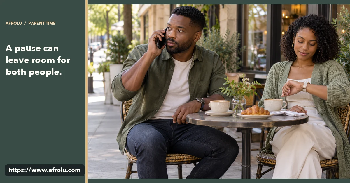 An adult parent takes a phone call at a cafe while an adult date gives them space.