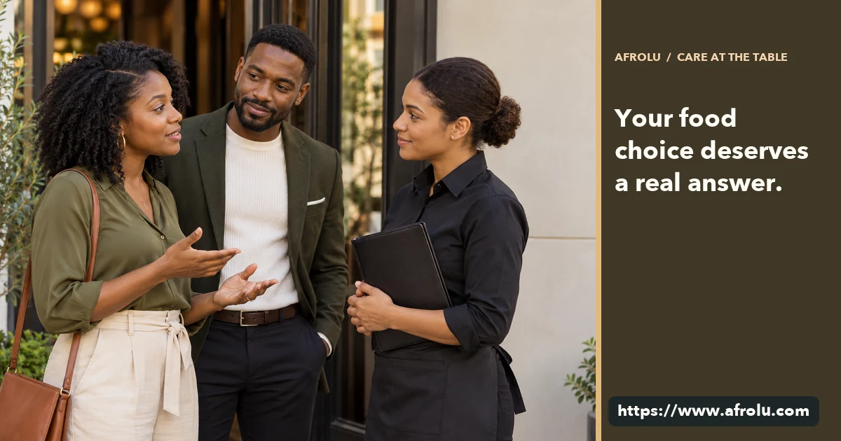 Two adult professionals speak with a restaurant employee before choosing a meal.