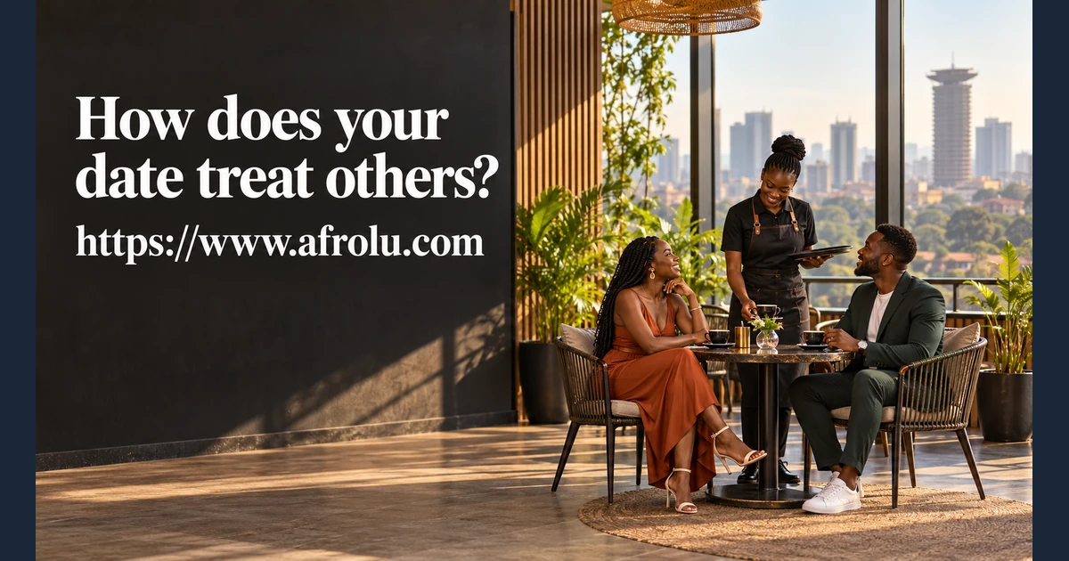 Two adults sit at a café table near a worker.