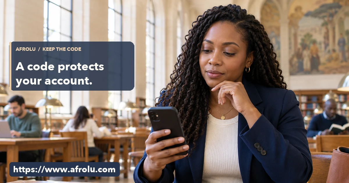 An adult professional pauses over a phone while sitting at a bright public library table.