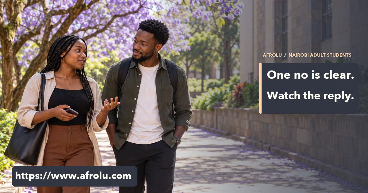Two adult Black university students walking together on a jacaranda-lined campus path in daylight.