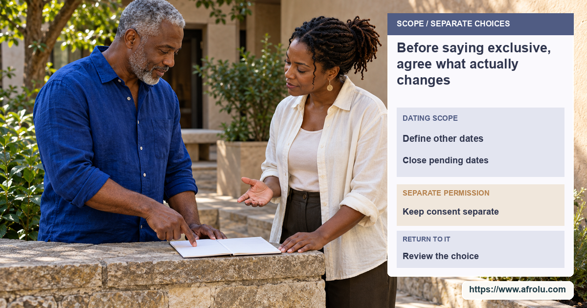Two adults stand across a low stone courtyard ledge and discuss an unmarked paper planner.