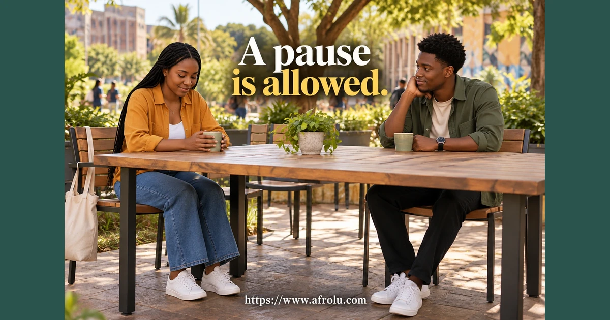 Two adult students pause their conversation at an outdoor table.