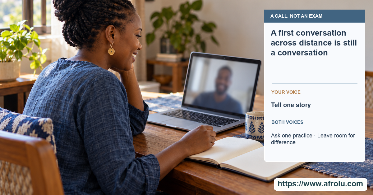 An adult at a quiet home table with an unmarked notebook speaks warmly on a video call; the screen reveals no readable person or text.