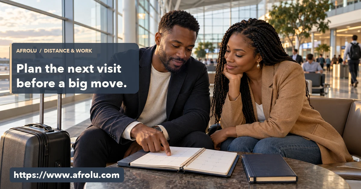 Two adult Black professionals review a blank calendar together in an airport seating area.