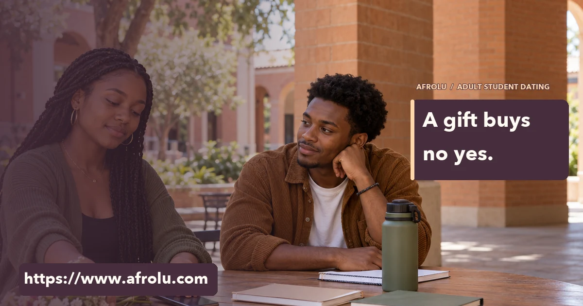 Two adult students at a campus table with a bouquet and phone between them.