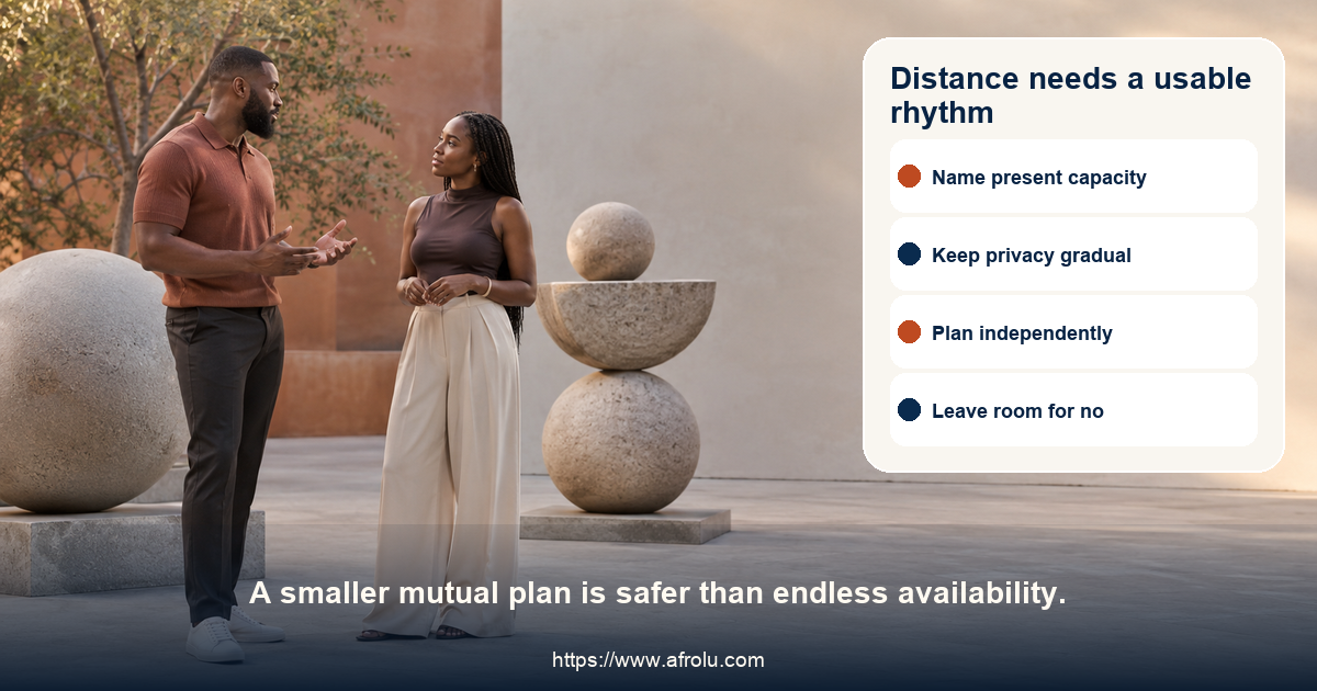Two clearly adult people in a neutral modern public courtyard having a calm conversation beside abstract balanced stone forms, with no travel or cultural markers.