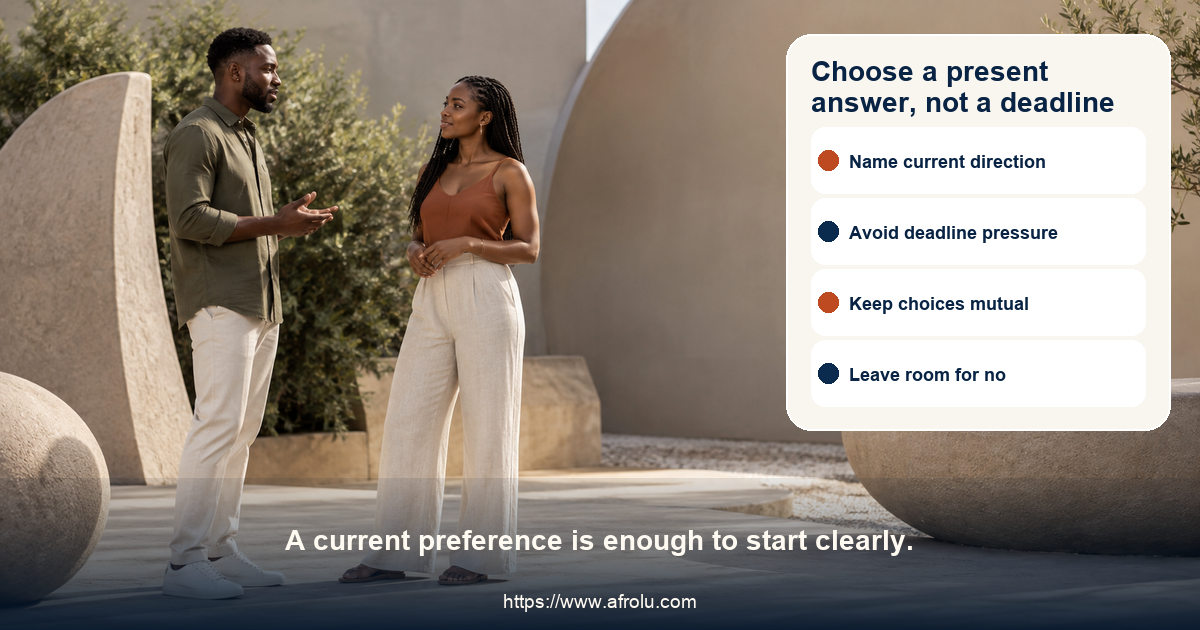 Two clearly adult people in a neutral contemporary courtyard having an attentive conversation beside abstract balanced forms, with no age, family, or status cues.