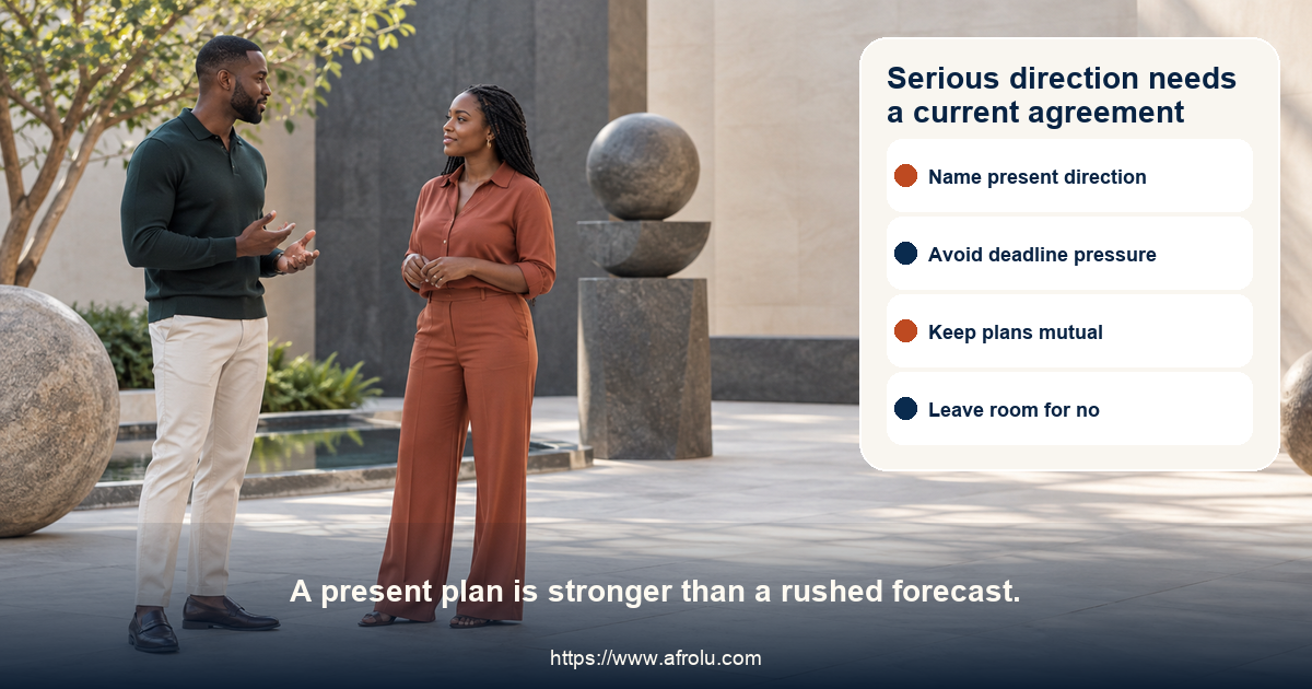 Two clearly adult people in a neutral contemporary public courtyard having an attentive conversation beside abstract balanced stone forms, with no campus, youth, city, or landmark cues.