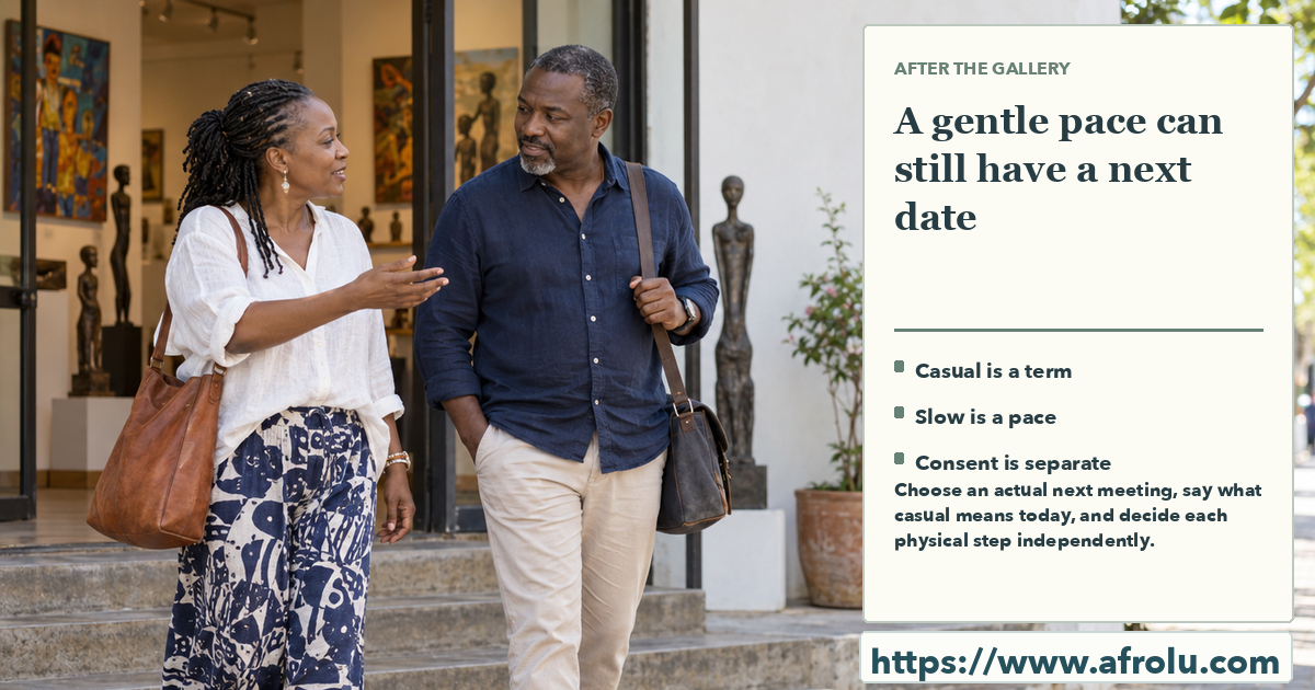 Two mature adults talking as they walk outside an art gallery in daylight, with comfortable space between them.