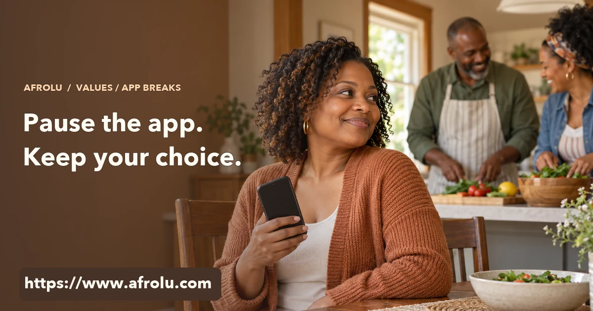 An adult holds an unlit phone and turns toward friends preparing a relaxed Sunday meal.