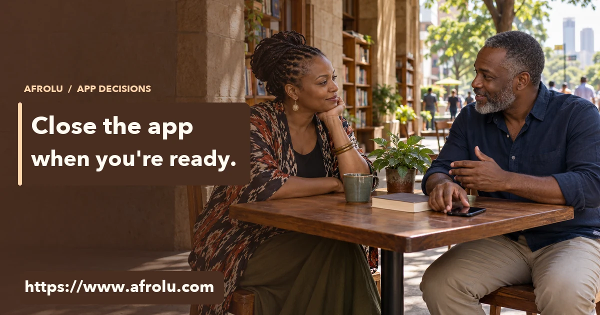Two adults in their fifties talk at a public bookshop veranda with a blank-screen phone set aside.