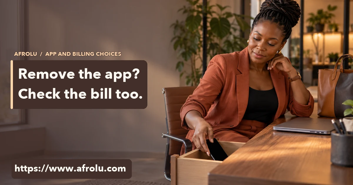 Adult Black professional woman puts a blank phone in a desk drawer at the end of work.