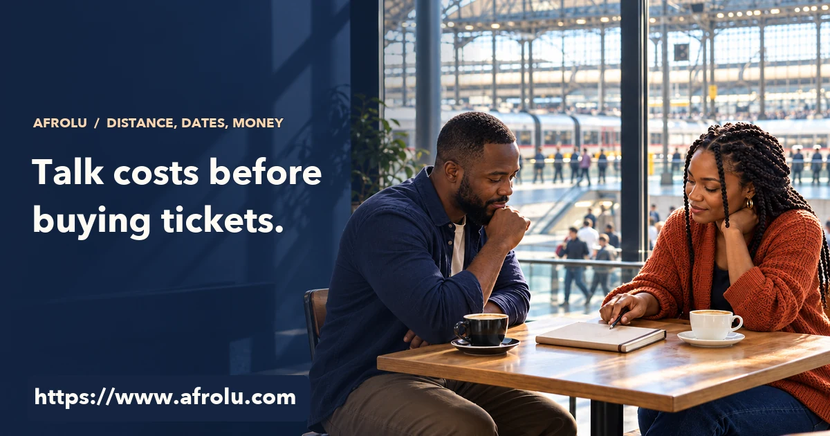Two adults calmly discuss plans over separate cups at a public station cafe, with a closed notebook between them.