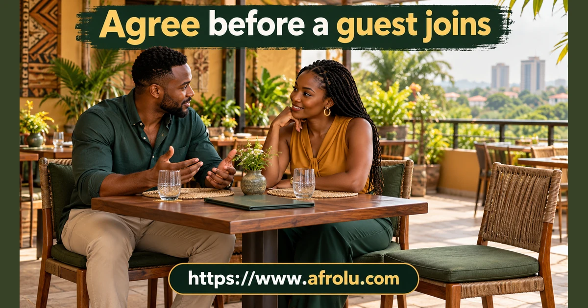 Two adults talk at a restaurant table beside an empty chair.