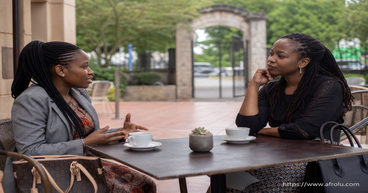 Two adult Kenyan friends discuss whether a first name may be shared for a community introduction